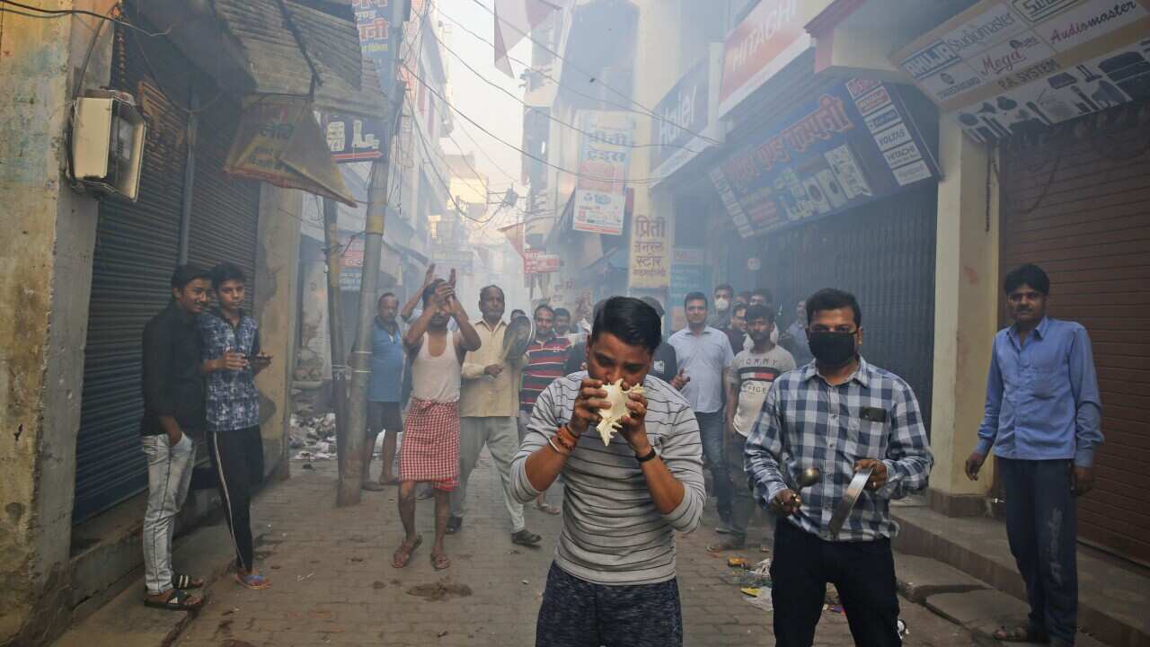 Indians bang pans, blow con shells and claps in show of appreciation to health care workers in Prayagraj, India