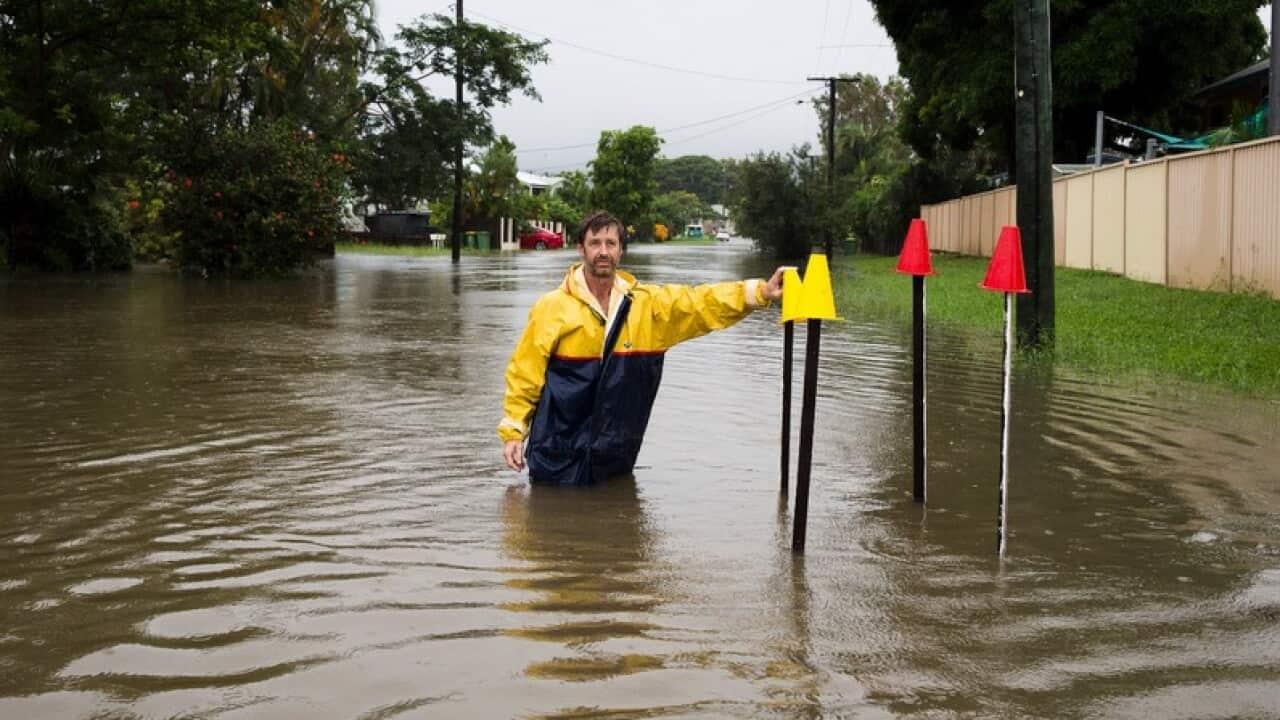 Local resident Paul Shafer standing in floodwaters in Hermit Park Townsville.