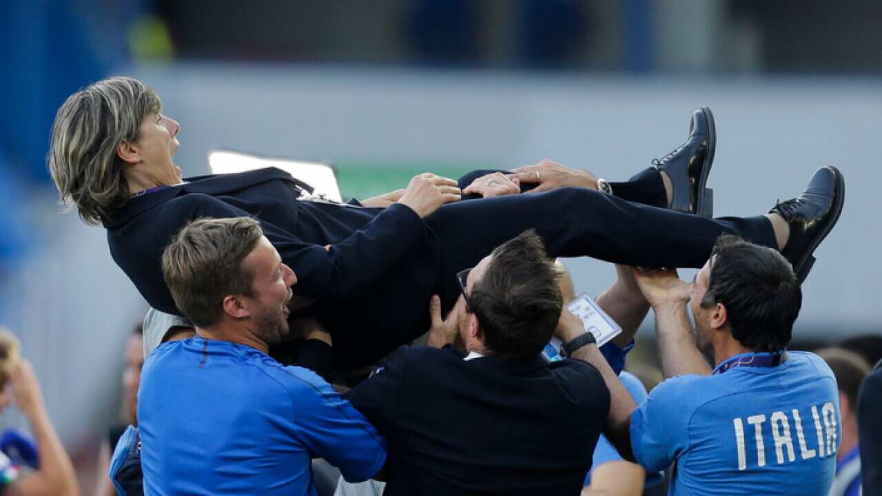 Italy head coach Milena Bertolini is thrown into the air by members of her team at the end of the Women's World Cup match between Italy and China.