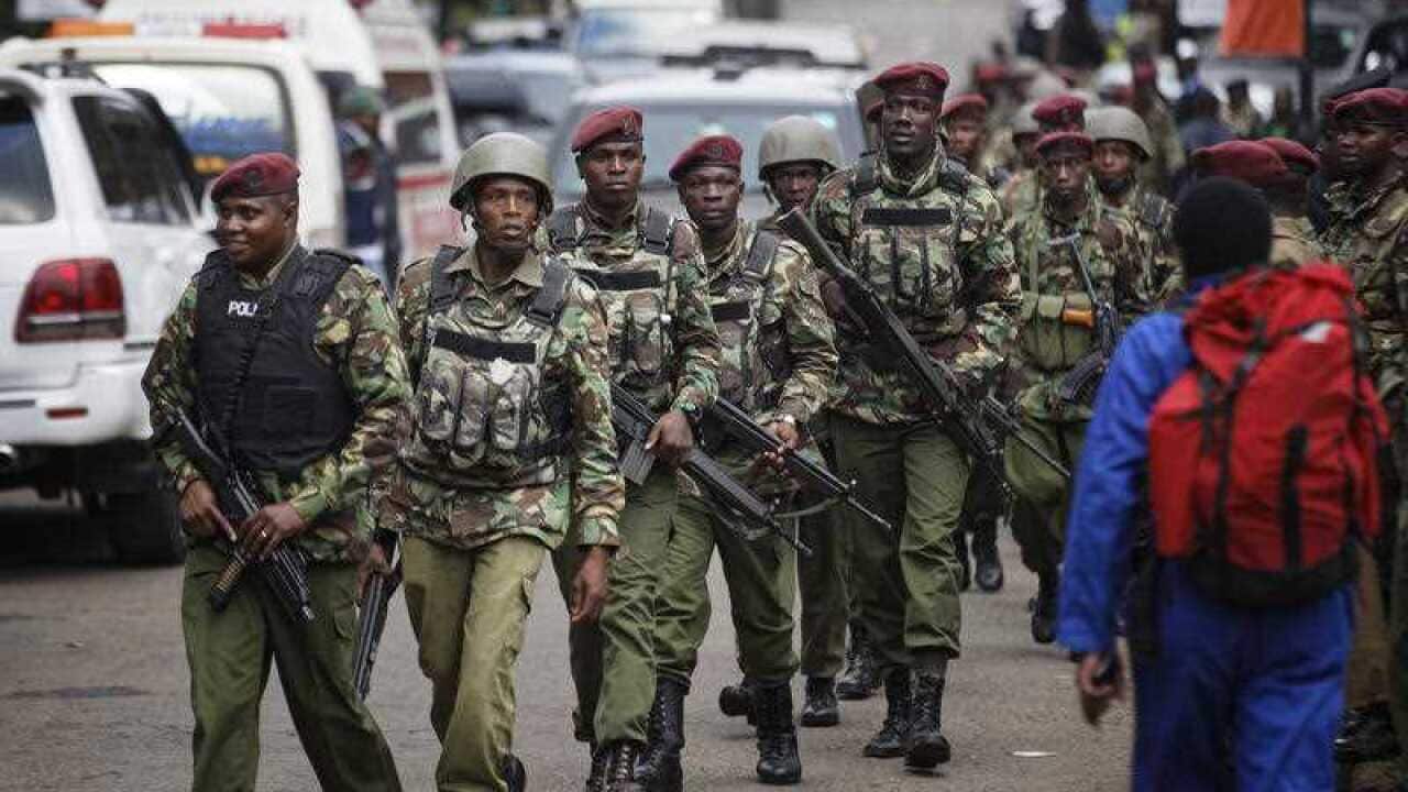 Kenyan security forces walk from the scene of the hotel attack.