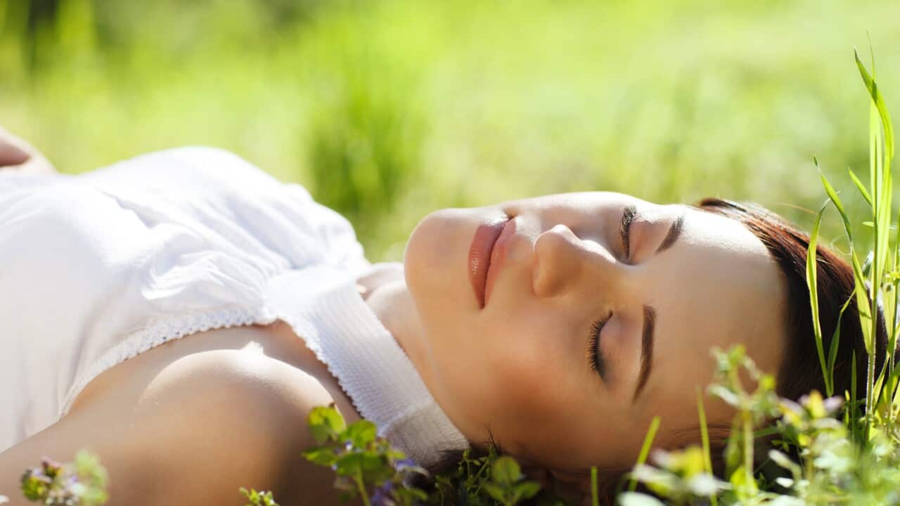 Young Woman Sleeping On Grass