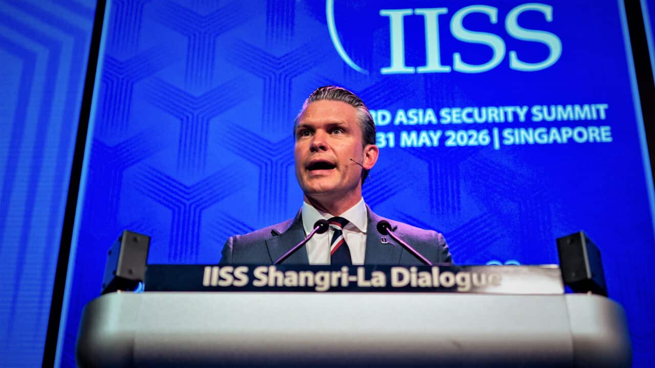 Pete Hegseth speaks from a podium at the Shangri-La Dialogue security summit.