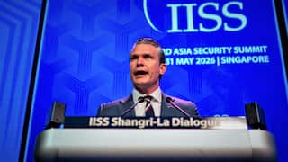 Pete Hegseth speaks from a podium at the Shangri-La Dialogue security summit.