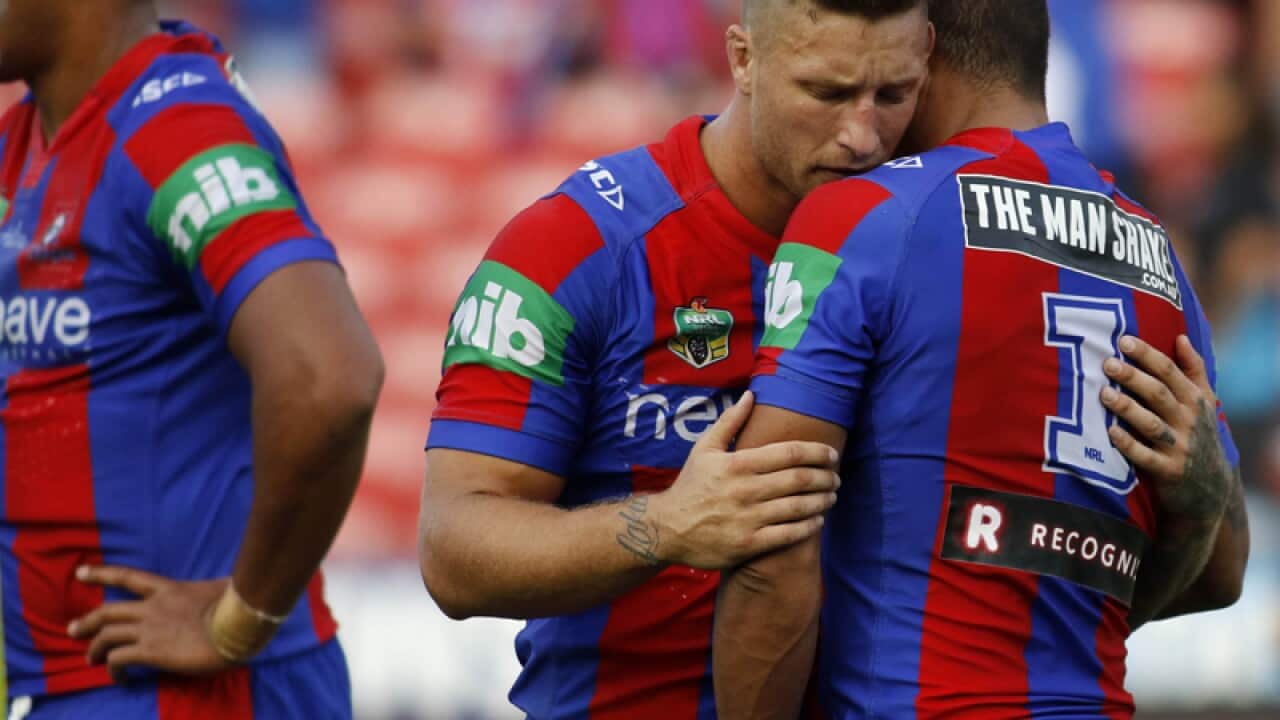 Tariq Sims comforts Dane Gagai of the Knights
