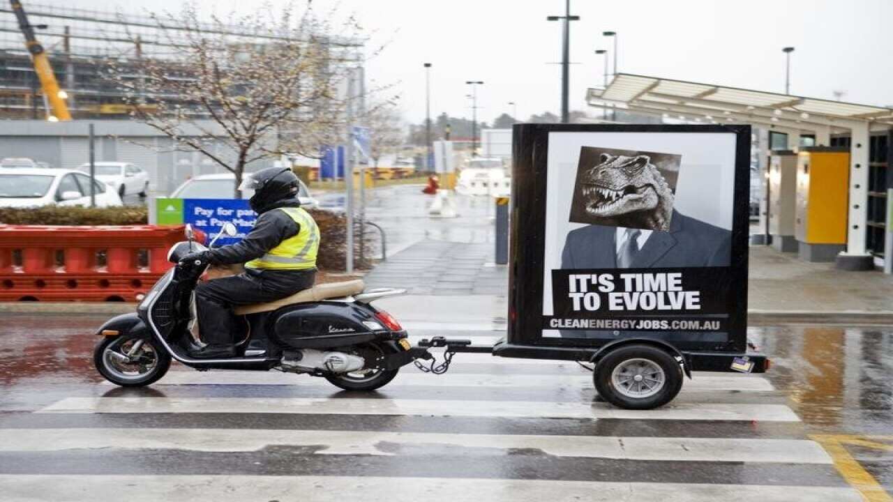 A demonstrator with a poster calling for climate change action.
