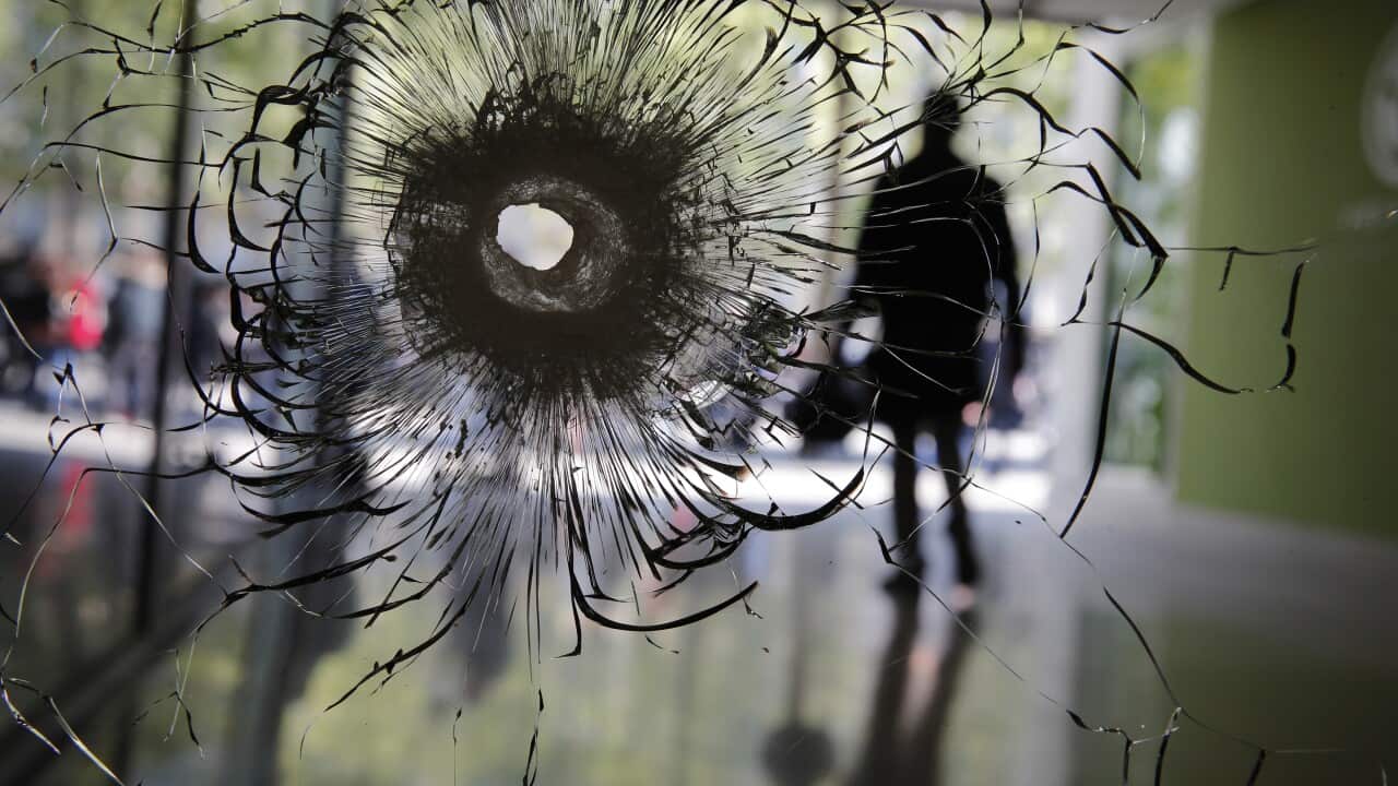 A bullet hole seen in a window on the Champs Elysees following the attack in Paris.