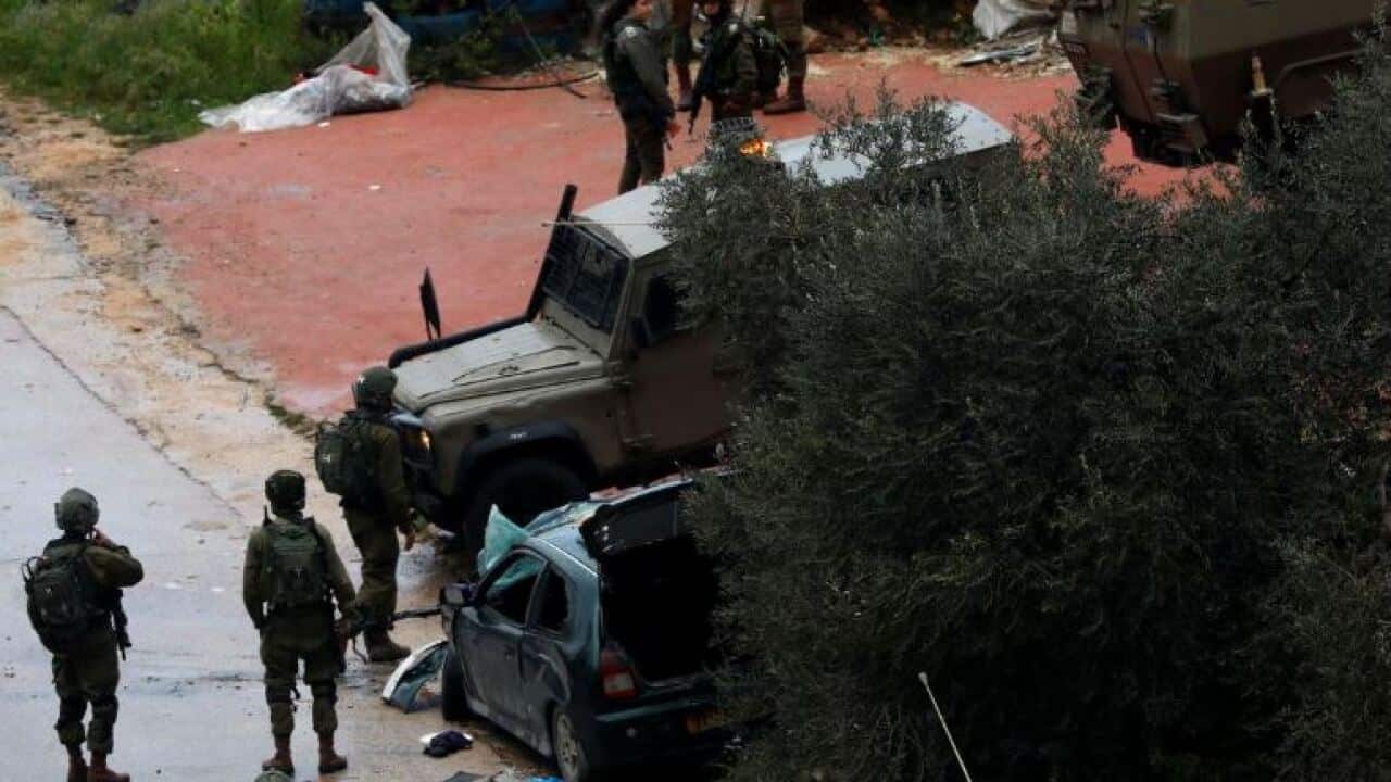 Israeli forces gather at the scene of an incident near Ramallah, in the Israeli-occupied West Bank.