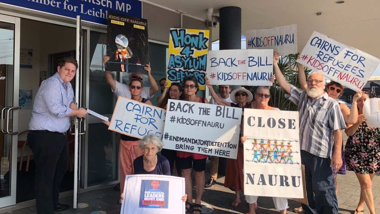 Protesters rallied outside Liberal MP Warren Entsch's office in Cairns. 