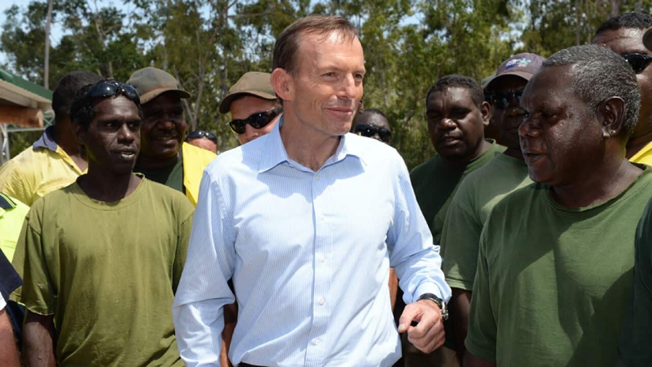 Opposition leader Tony Abbott speaks to aboriginals at the Garma Festival in Gove, Arnhem Land, Saturday, Aug. 10, 2013. (AAP Image/Alan Porritt) NO ARCHIVING