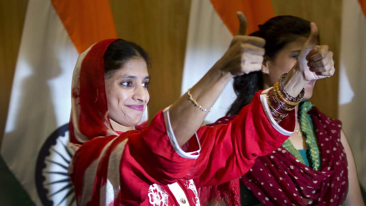 Geeta, 23, right, a deaf and mute Indian woman who accidentally strayed into Pakistan as a child 12 years ago, displays thumbs up symbol after a press conference in New Delhi, India, Monday, Oct. 26, 2015. (AP Photo/Manish Swarup)