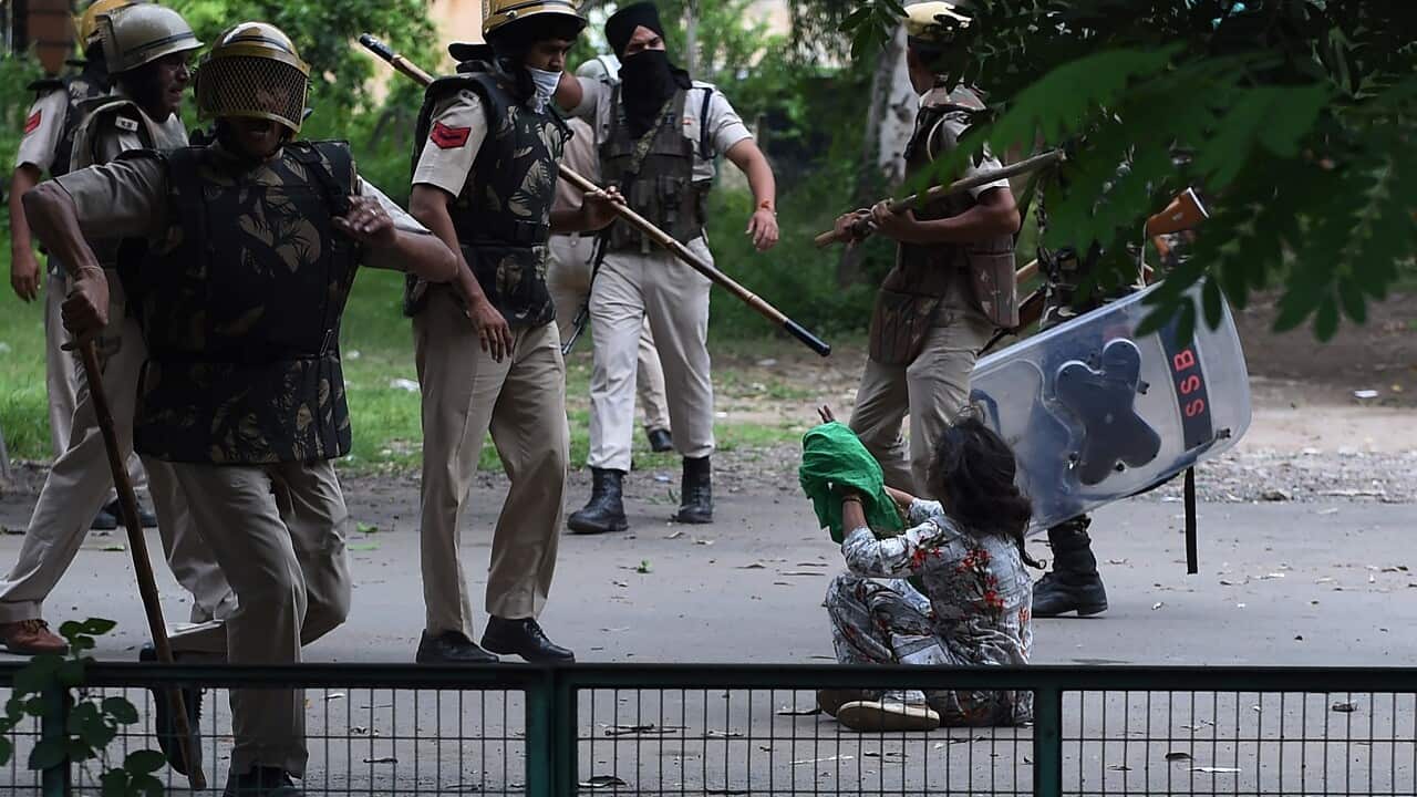 A follower of Indian religious leader Gurmeet Ram Rahim Singh pleads for her safety during clashes between controversial guru's followers and security forces.