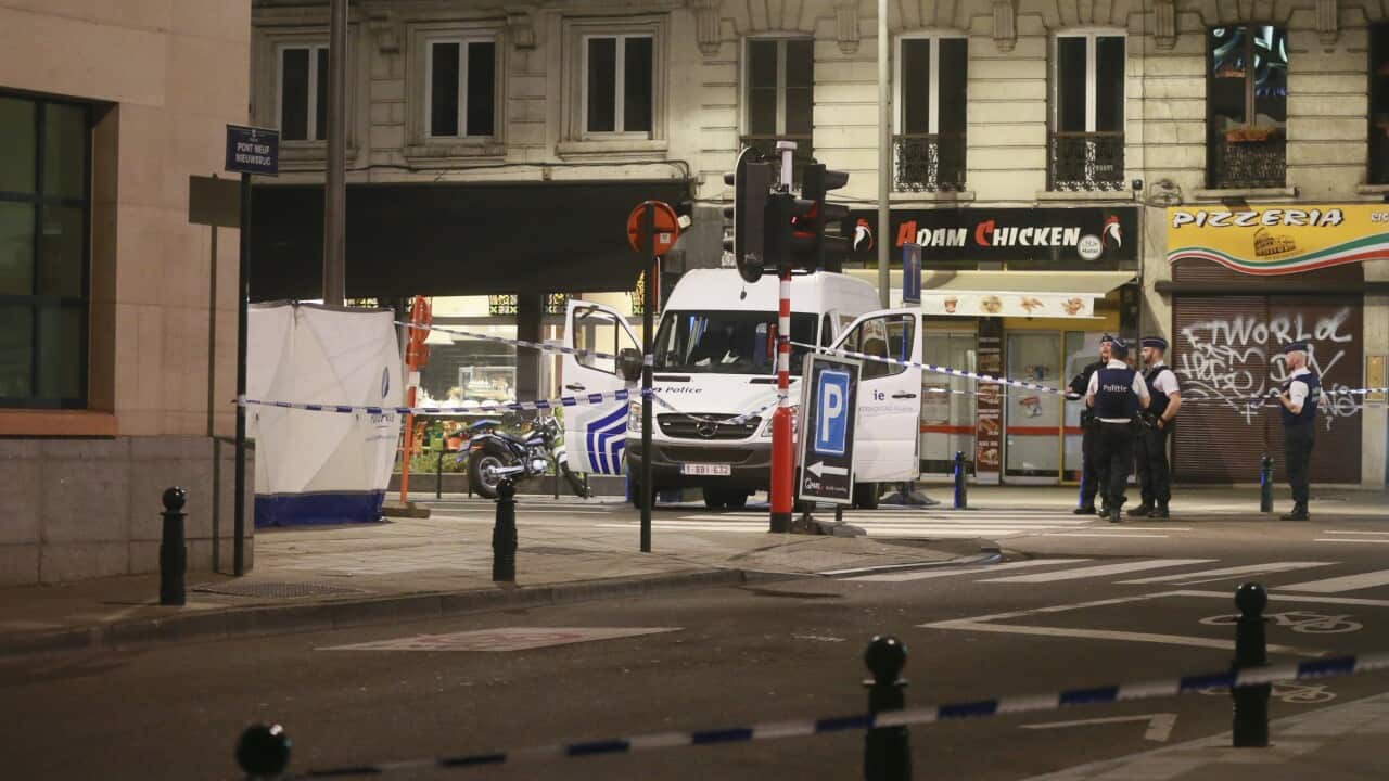 Police and forensic experts investigate at the scene of the attack in central Brussels.
