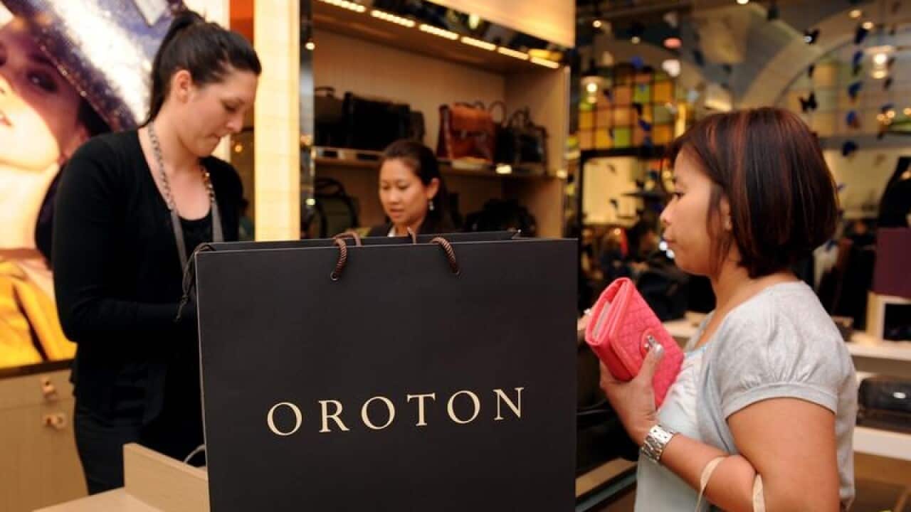 A customer purchases a product at an Oroton store