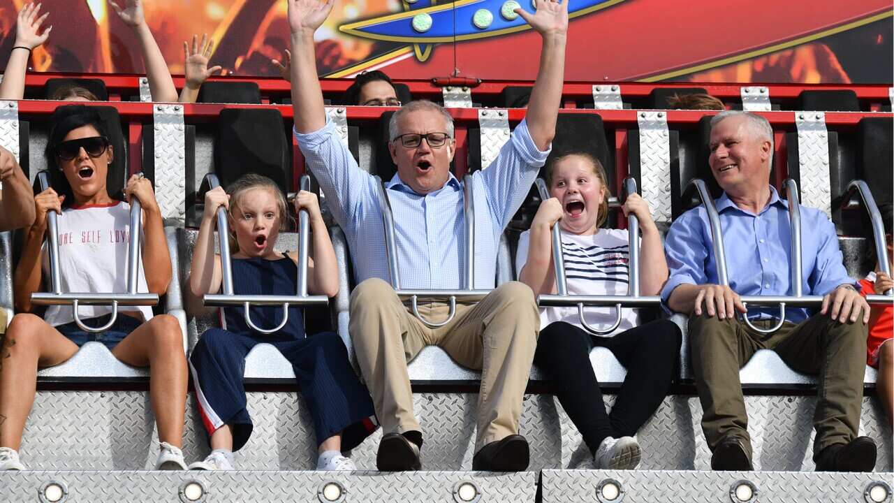 FILE. Prime Minister Scott Morrison with daughters Lily (L) and Abbey (R) and Deputy Prime Minister Michael McCormack ride the Rock Star ride at the Royal Easter Show at the Olympic Park Showgrounds in Sydney, Sunday, April 21, 2019.
