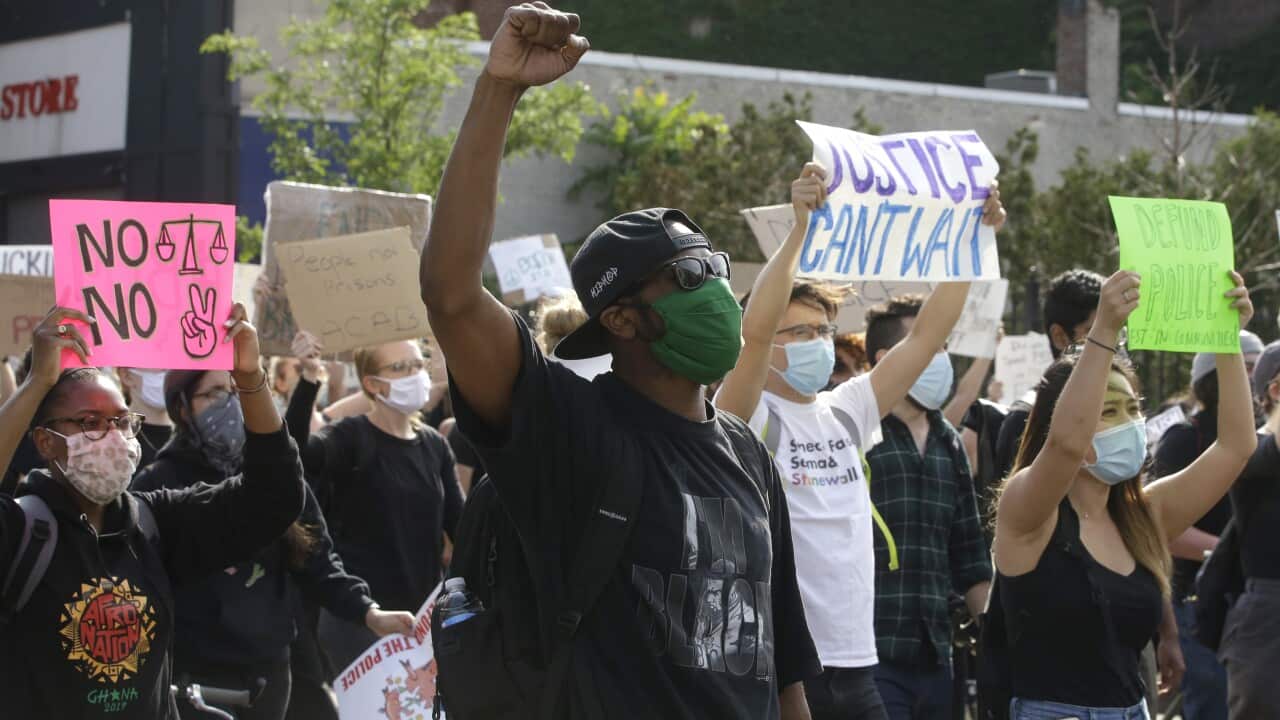 Demonstrators display placards during a protest against police brutality in Boston.