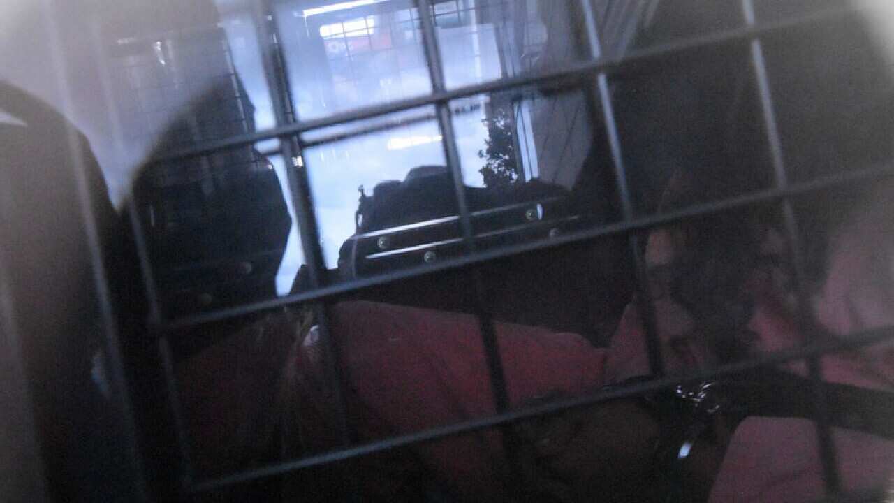 Belal Betka is seen in a prison van leaving Bankstown Local Court, Sydney