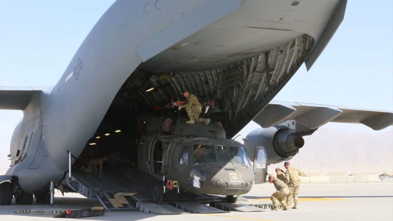 Loading a Blackhawk helicopter into a C-17 Globemaster III in support of the Resolute Support retrograde mission in Afghanistan,