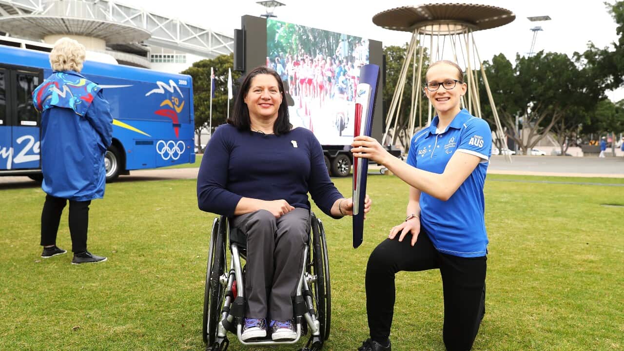 Paralympians Louise Sauvage and Tamsin Colley with the Sydney 2000 Paralympic torch before re-lighting of the Olympic cauldron to celebrate the 20th anniversary