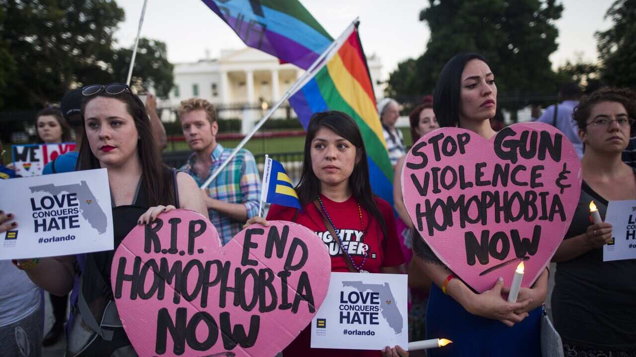 Members and supporters of the LGTBQ community attend a candlelight vigil outside the White House.