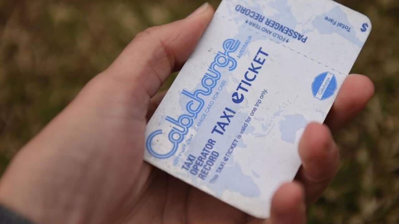 A holds a credit card-like Cabcharge e-ticket