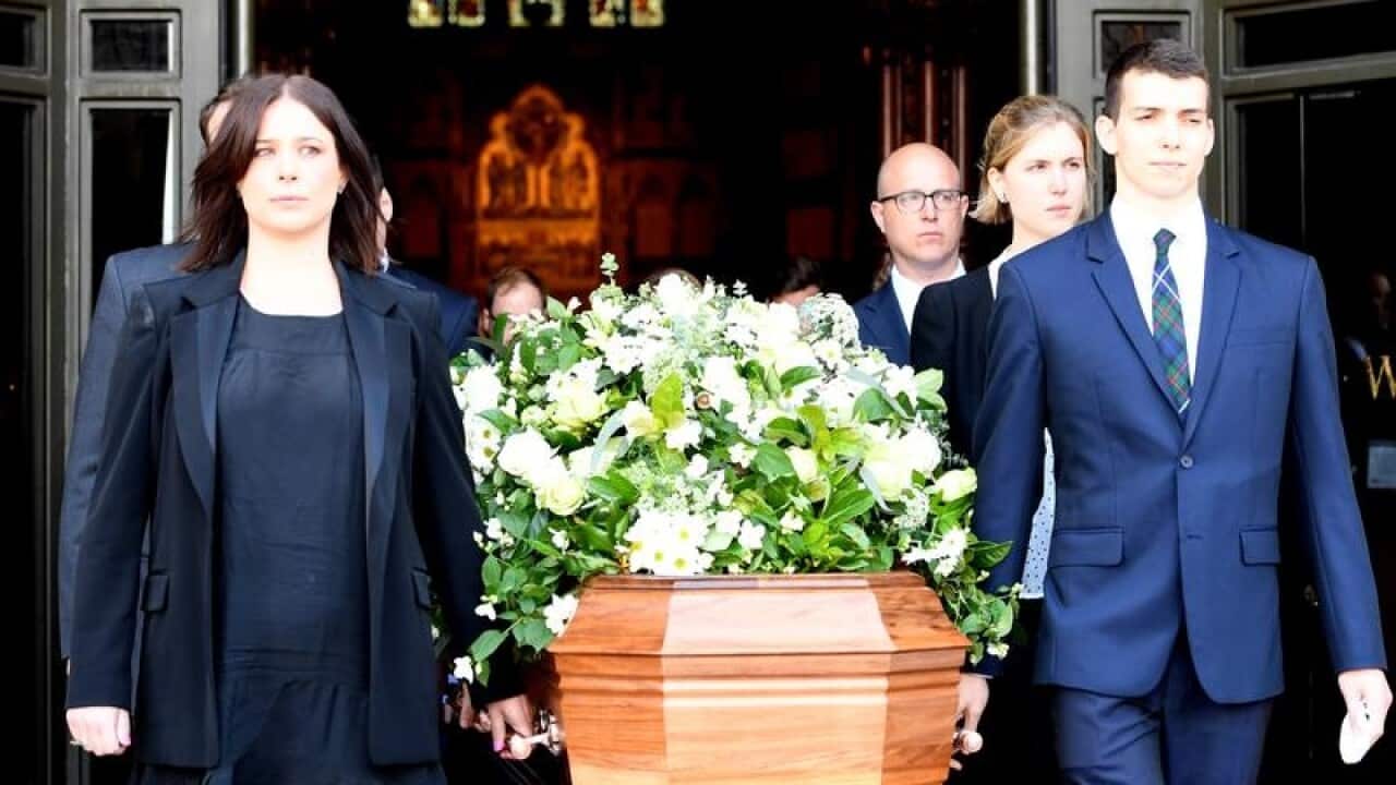 Pallbearers lead the casket of Sir Ninian Stephen