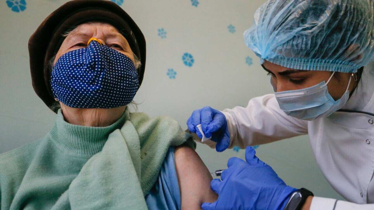 A medical worker injects an anti influenza vaccine to patient.