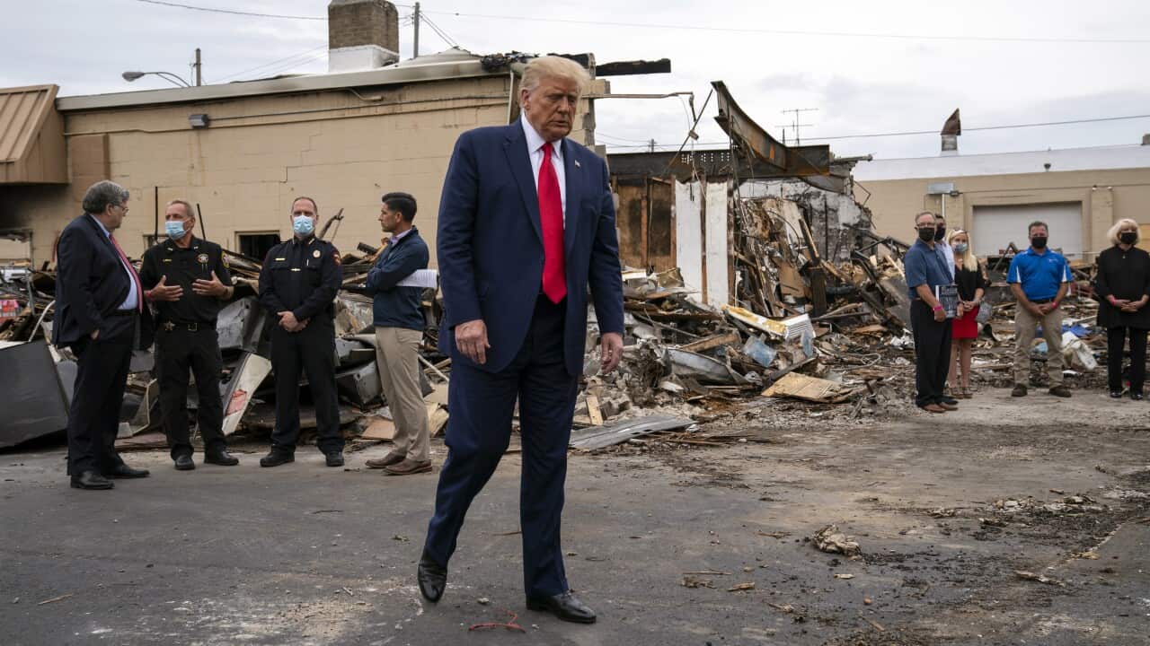 President Donald Trump tours an area that was damaged during demonstrations in Kenosha