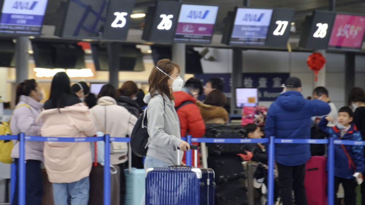 A woman wears a mask at Shanghai Pudong International Airport on Jan. 26, 2020, amid the spread of pneumonia caused by a new coronavirus in the central Chinese city of Wuhan. (Kyodo via AP Images) ==Kyodo