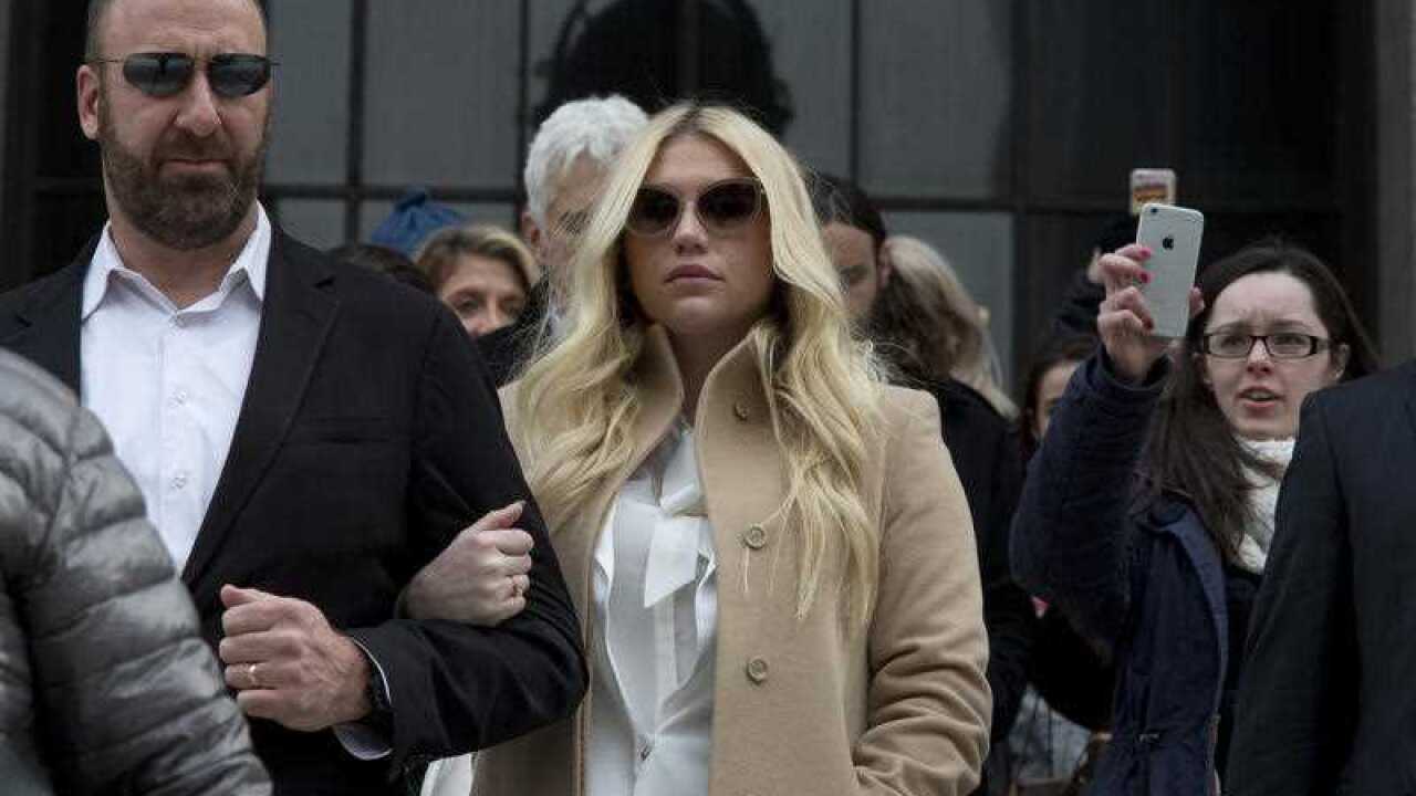 Pop star Kesha, center, leaves the Supreme court in New York.
