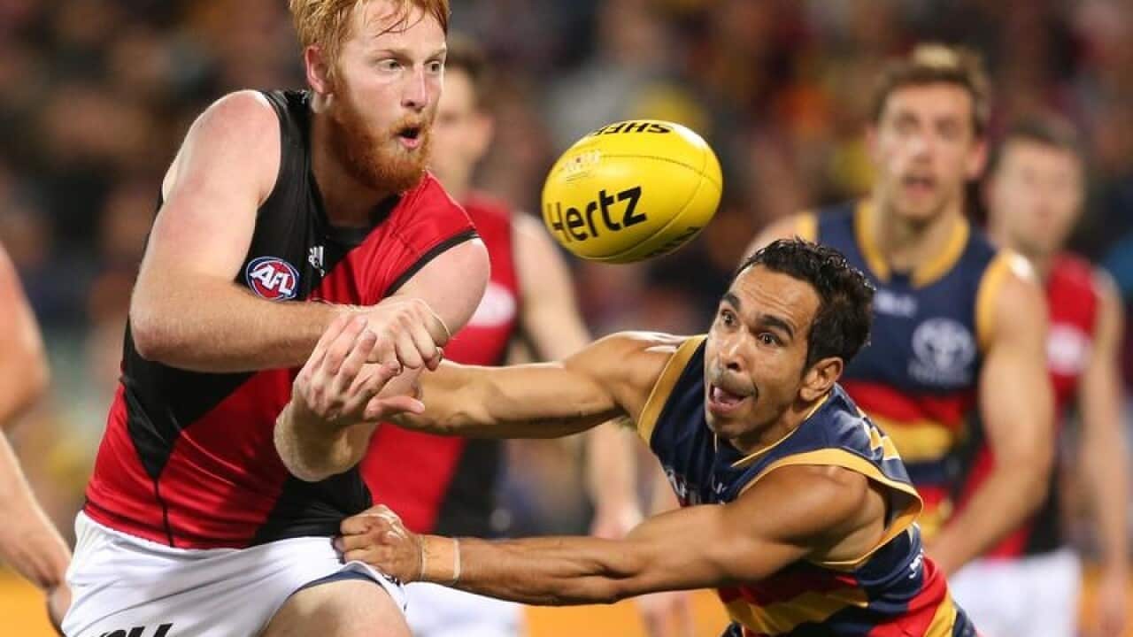 Aaron Francis of the Bombers gets a hand ball away.