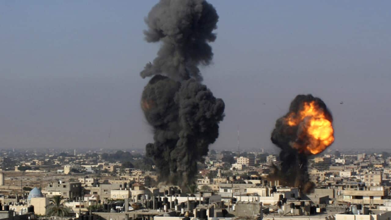 A Palestinian walks amid the rubble of the Omar Ibn Abdul Aziz mosque