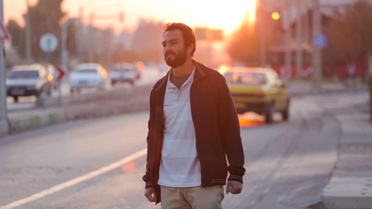 Man standing on the street at sunset