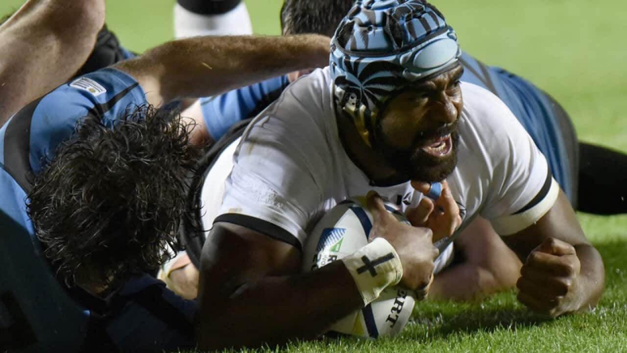 Fiji's Tevaita Cavubati celebrates after scoring a try