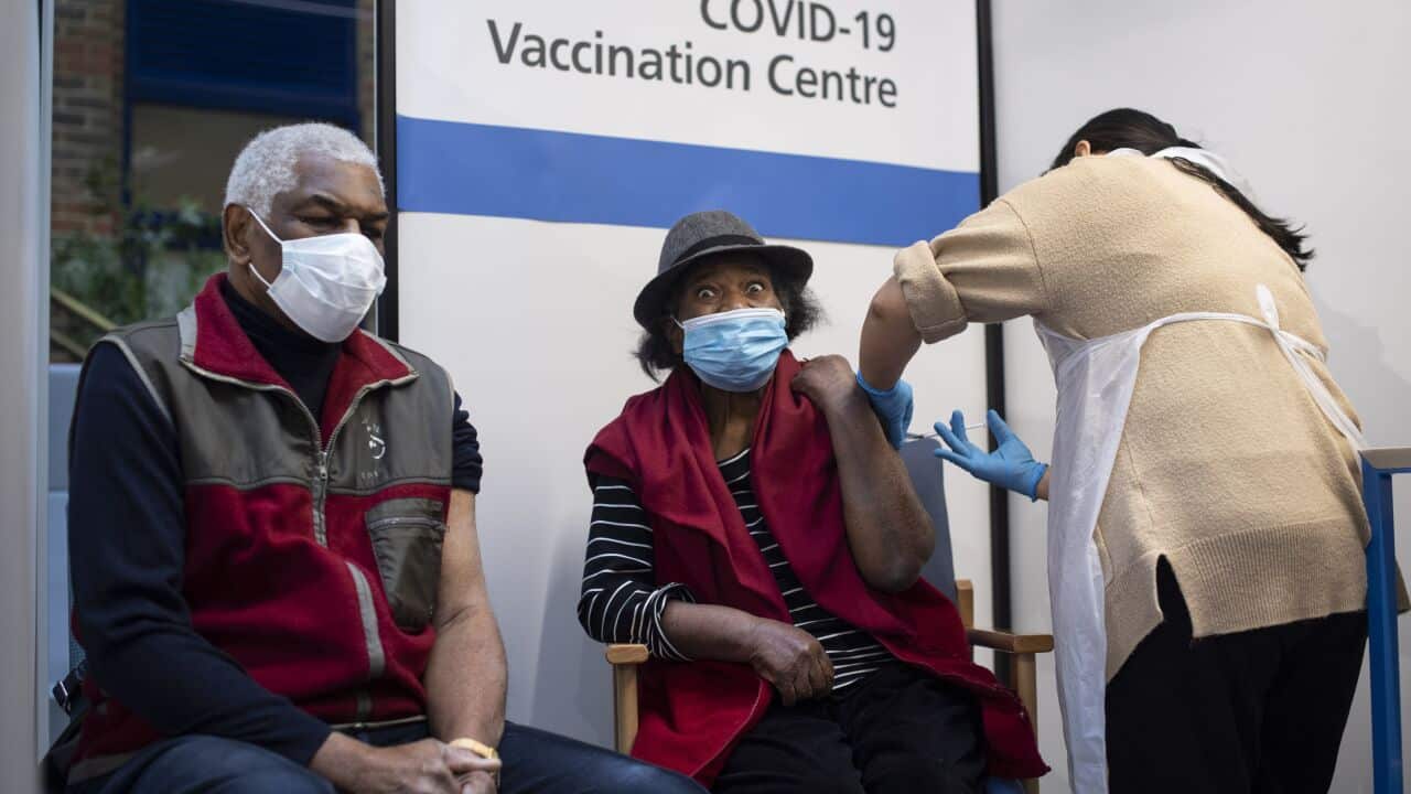 Lorna Lucas, 81, receives the first of two Pfizer COVID-19 vaccine jabs shortly before her husband, Winston also has one administered at in London, 8 December.