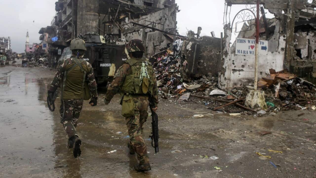 Filipino soldiers conduct patrols in the ruined city of Marawi, as Australia announces more military support.