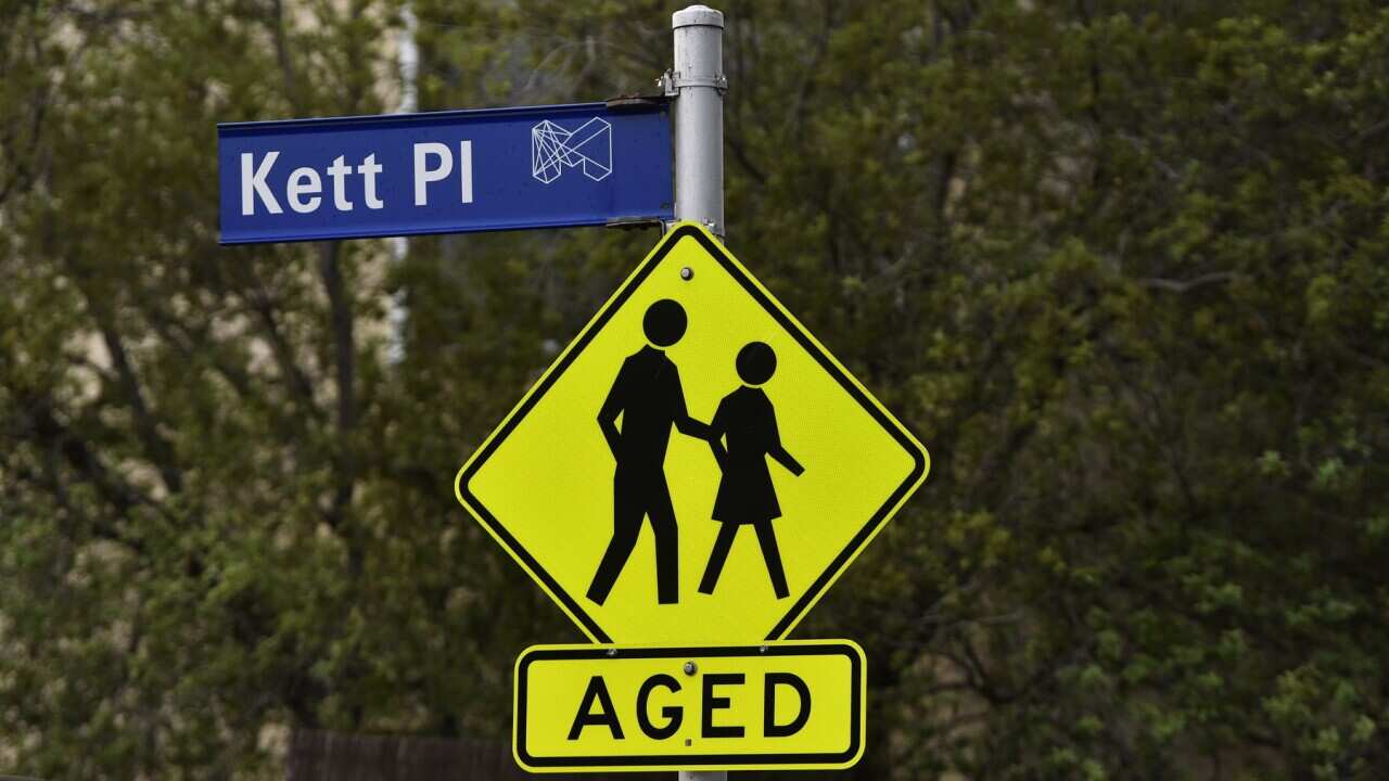 A hazard sign warning drivers of elderly members crossing the street is seen in Kensington, Melbourne, Saturday, March 30, 2019. Aged Care stock for federal budget. (AAP Image/James Ross) NO ARCHIVING