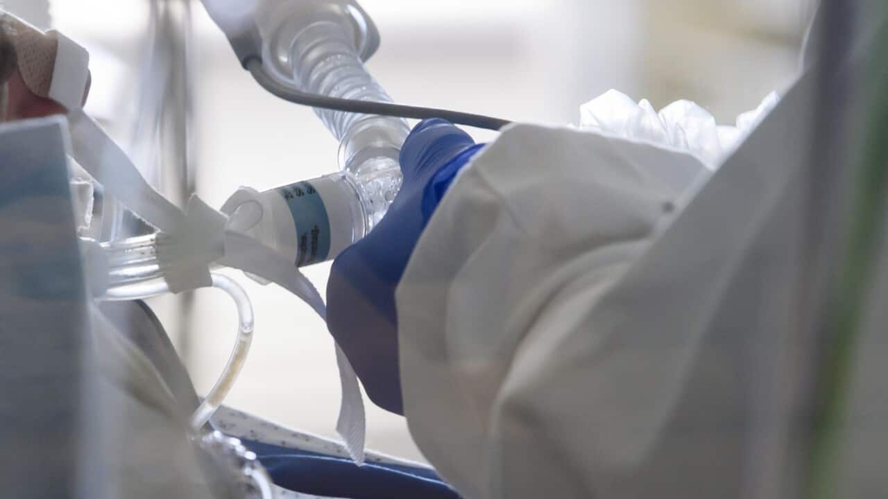 An intubated patient inside an intensive care unit
