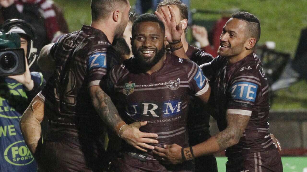 Sea Eagles players celebrate after scoring a try