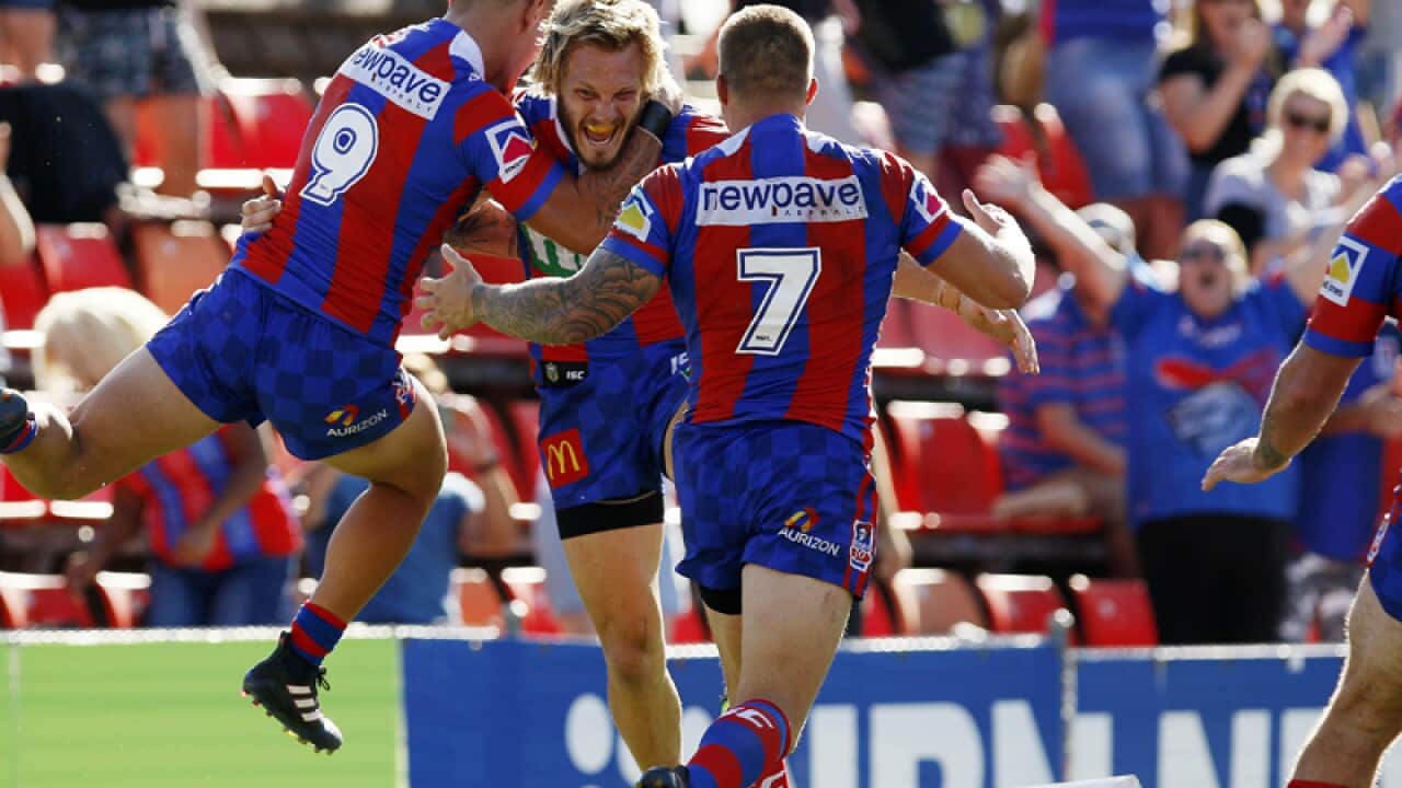 Nathan Ross of the Knights (centre) celebrates