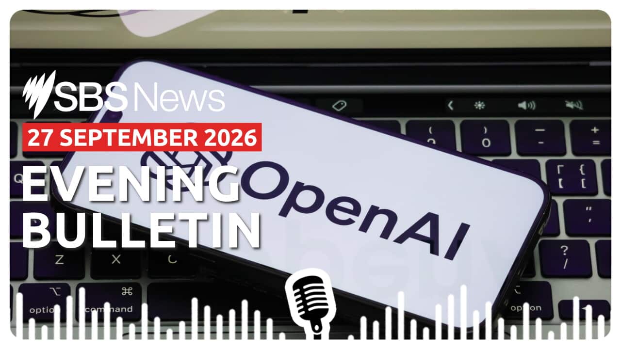 The OpenAI logo seen on a mobile phone sitting on a keyboard.