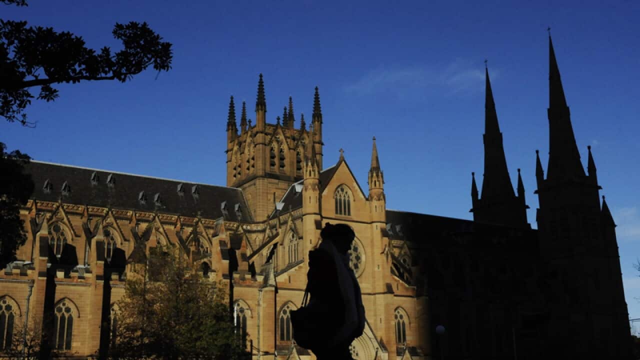 A pedestrian walking in front of St Mary's Cathedral