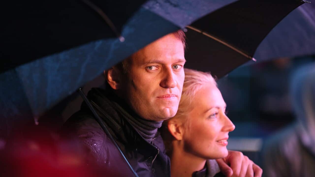 Moscow mayoral candidate Alexey Navalny (L) and his wife Yulia attend his last election campaign event during heavy rain in Moscow, Russia 06 September 2013