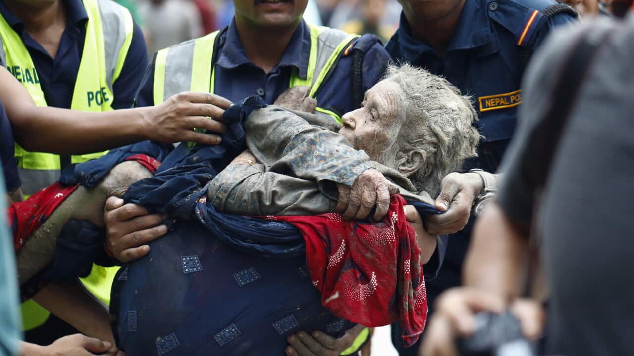 An elderly woman is rescued from buildings and