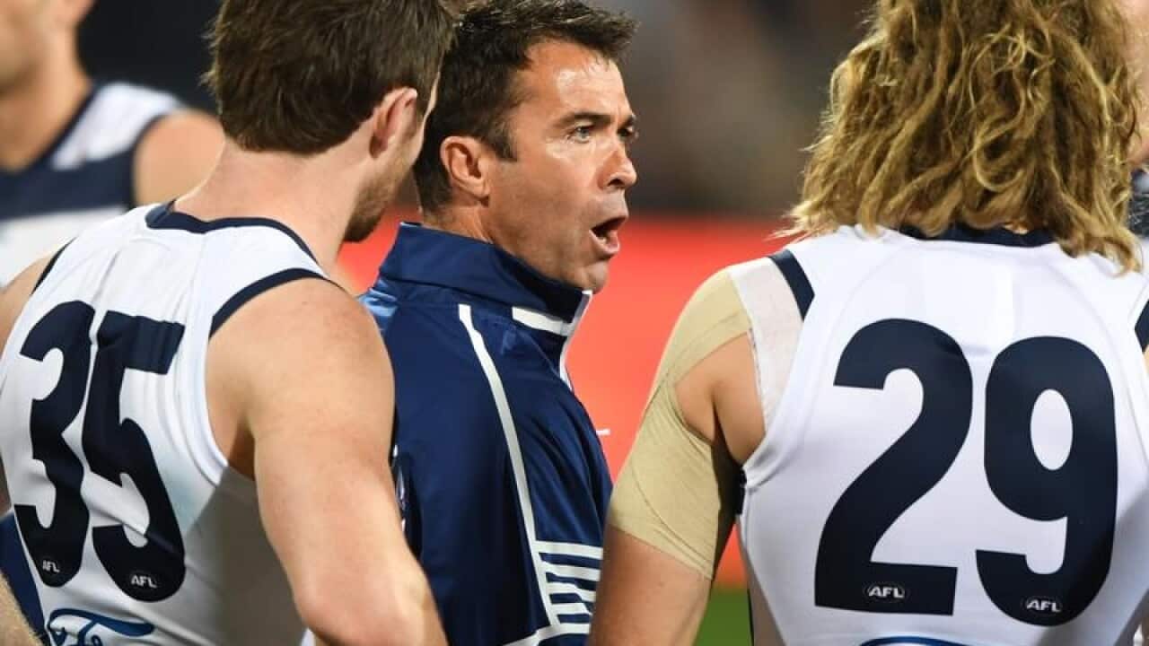 Geelong Cats coach Chris Scott (centre).