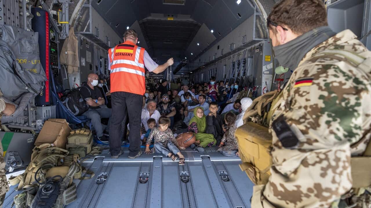 Evacuees from Afghanistan are briefed by German Air Force upon arrival at Tashkent airport, Uzbekistan