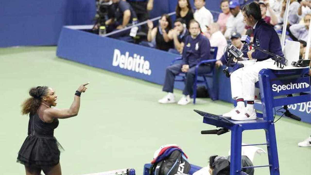 Serena Williams of the US gestures towards chair umpire Carlos Ramos (R) as she plays Naomi Osaka of Japan during the women's final.