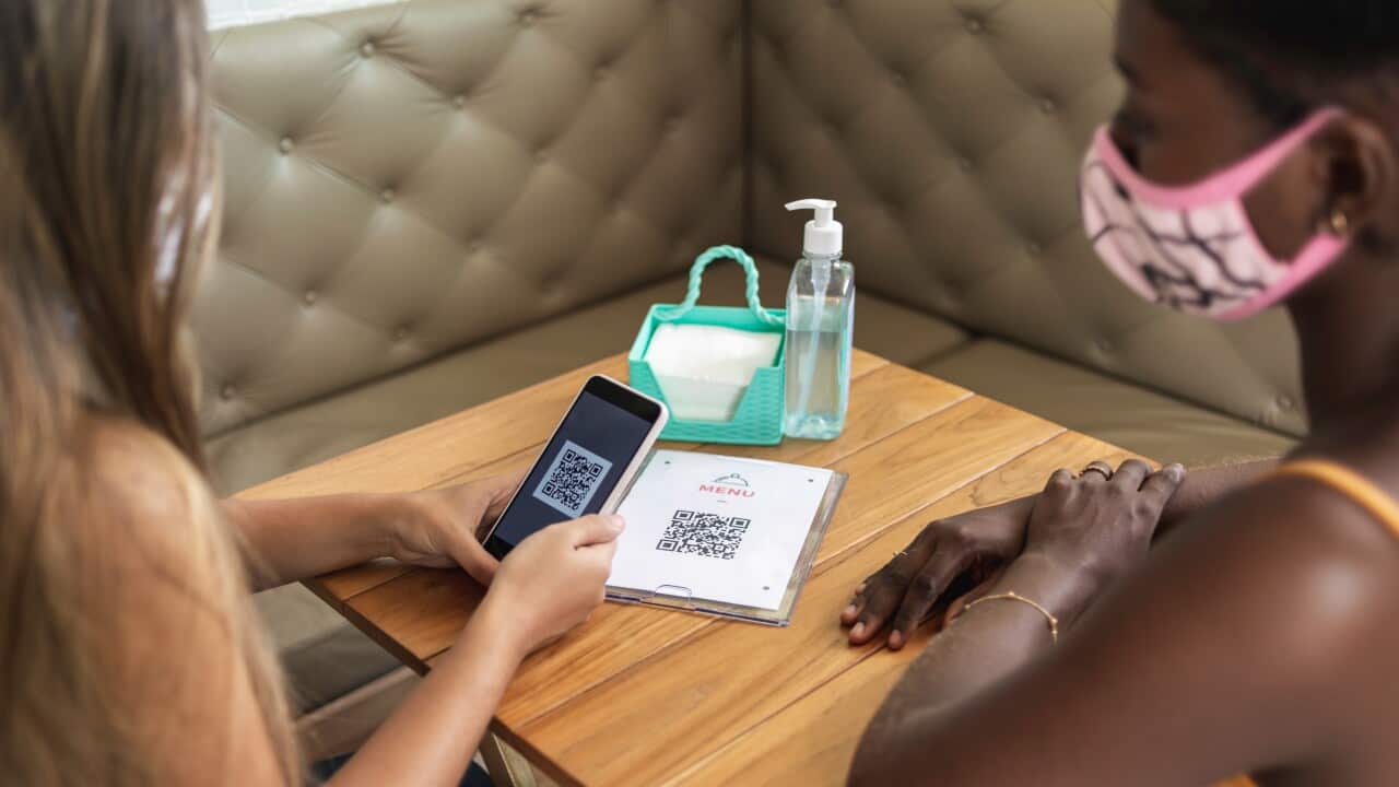 Customer scanning QR code to view food menu online
