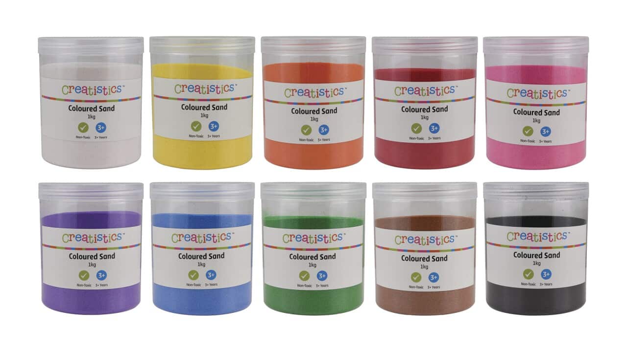 Buckets of coloured sand products against a white background.