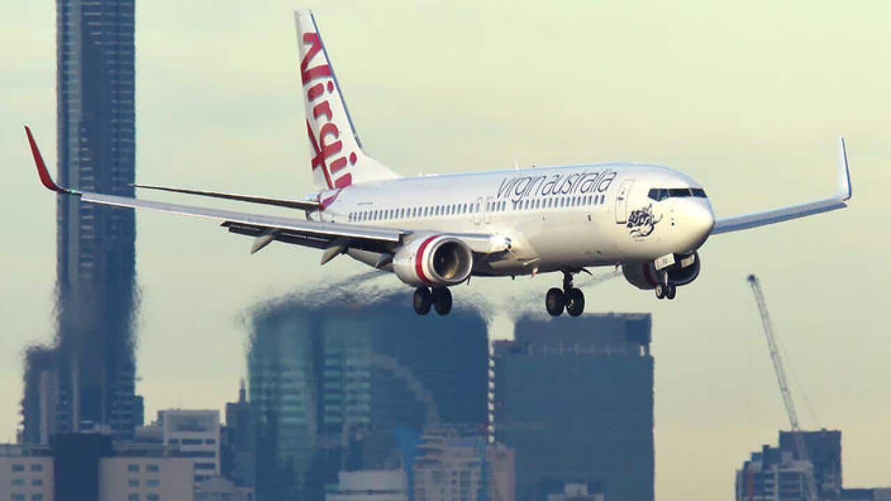 A Virgin Australia plane is seen on approach into Brisbane airport, Wednesday, May 4, 2016. (AAP Image/Dave Hunt) NO ARCHIVING