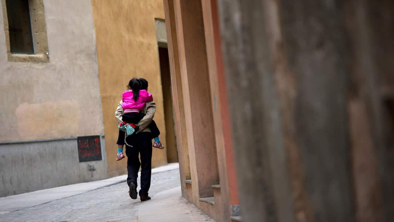 Father and daughter walking in street